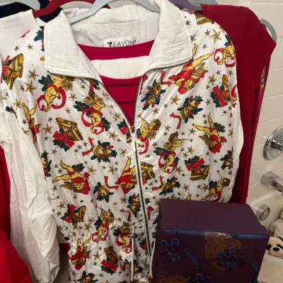 Sale Photo Thumbnail #181: Vintage Lavon brand windbreaker track jacket featuring a festive Christmas print of cherubs, bells, and stars over a white base.