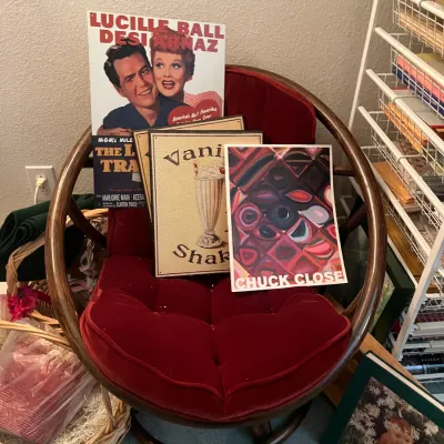 Sale Photo Thumbnail #229: Vintage bentwood round swivel accent chair with tufted red velvet upholstery, displayed with various art prints and posters.