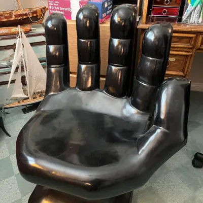 Sale Photo Thumbnail #201: Novelty black glossy hand-shaped chair with a pedestal base in good vintage condition.