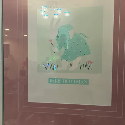 Sale Photo Thumbnail #167: Framed Paris Bottman art print depicting a rabbit in a green floral dress, presented under glass with double pink matting and a teal frame.