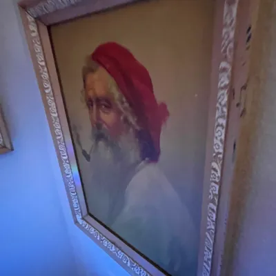 Sale Photo Thumbnail #86: Framed portrait print depicting a bearded man with a pipe and a red cap, housed in an ornate carved wooden frame.