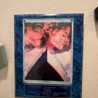 Sale Photo Thumbnail #68: Framed Titanic (1997) movie poster acrylic plaque commemorating the 1998 Academy Awards, featuring a blue faux-marble edge and engraved brass plate.