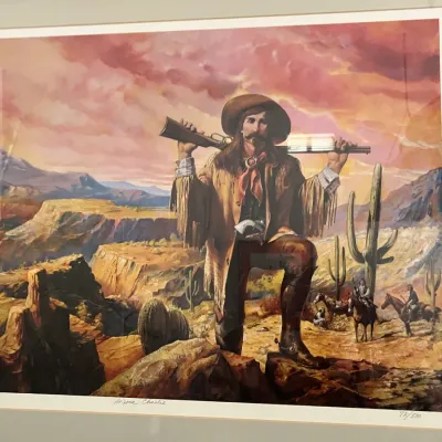 Sale Photo Thumbnail #253: Framed limited edition Western art print titled "Arizona Charlie," numbered 72/500, depicting a frontiersman with a rifle in a desert landscape.