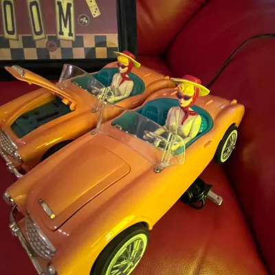Sale Photo Thumbnail #82: Pair of vintage-style yellow convertible car cassette players featuring driver figures in hats and sunglasses.