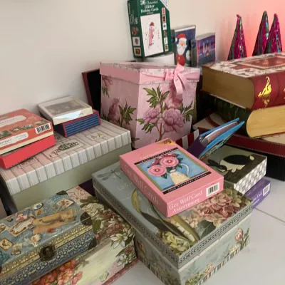 Sale Photo Thumbnail #236: Collection of decorative floral gift boxes, card assortments, and trinket boxes arranged on a table.