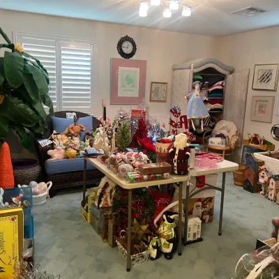 Sale Photo Thumbnail #175: A room filled with various seasonal holiday decorations, including Christmas ornaments, Santa figurines, plush Easter bunnies, and home decor items.