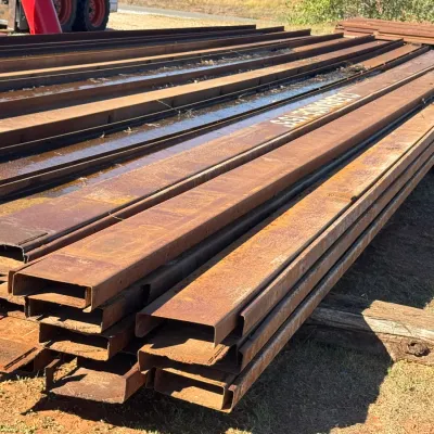 Sale Photo Thumbnail #12: Large stack of long, steel structural channels and I-beams.