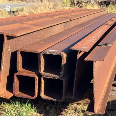 Sale Photo Thumbnail #8: Stack of structural steel I-beams and square tubing suitable for construction or heavy fabrication projects.