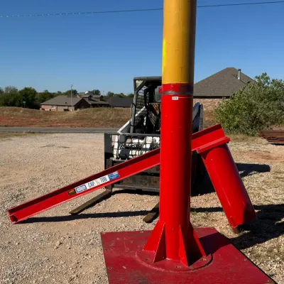 Sale Photo Thumbnail #16: Disassembled red industrial jib crane with a 1/2-ton capacity beam and a yellow-topped central support column.