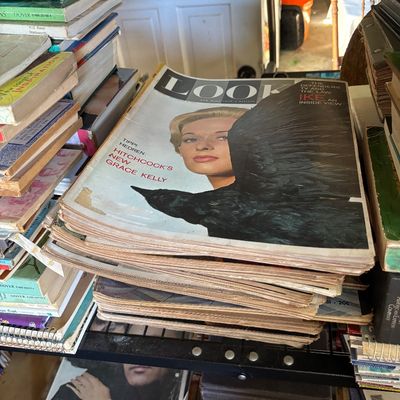 Sale Photo Thumbnail #3: Stack of vintage LOOK magazines from the 1960s, featuring a December 1962 issue with Tippi Hedren on the cover, alongside stacks of vintage books.