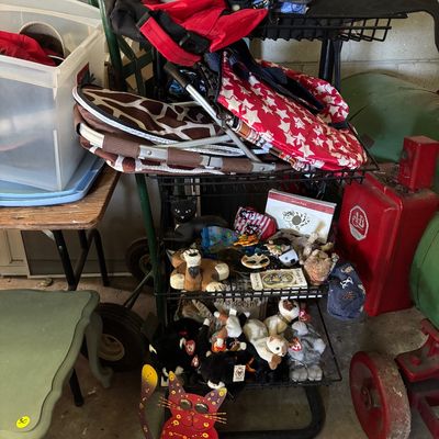 Sale Photo Thumbnail #94: Multi-tier wire cart filled with cat-themed decor, Ty Beanie Babies, folded fabric totes, and assorted collectibles.