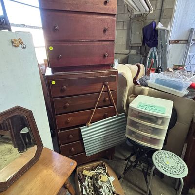 Sale Photo Thumbnail #17: Stacked wooden dressers, a small plastic storage drawer unit, and various household items in a storage room or garage setting.
