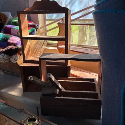 Sale Photo Thumbnail #35: Collection of vintage wooden items including a small wall shelf, a shoe shine valet, and a divided tote box alongside a colorful crocheted blanket.