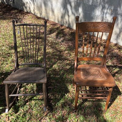 Sale Photo Thumbnail #91: Pair of antique wooden side chairs, including a dark-stained rocking chair with a perforated seat and a pressed-back oak chair with a woven cane seat.