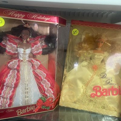 Sale Photo Thumbnail #102: Two vintage in-box Barbie dolls, including a 1990s Special Edition Happy Holidays African American Barbie and a Dream Bride Barbie.
