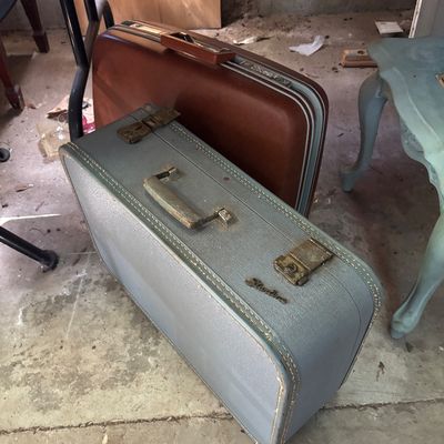 Sale Photo Thumbnail #71: Two vintage hard-shell suitcases, including a blue Shwayder Bros. Samsonite case and a brown molded suitcase, showing age-appropriate wear.