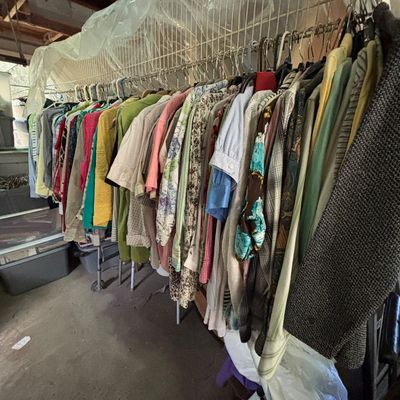 Sale Photo Thumbnail #108: Large rack of vintage women's clothing featuring patterned blouses, jackets, and button-up shirts.