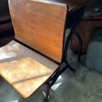 Sale Photo Thumbnail #70: Vintage school desk unit featuring a wooden seat, backrest, and desktop on a black wrought metal frame.