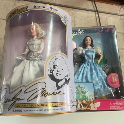 Sale Photo Thumbnail #99: Two NIB collector dolls, including a Silver Sizzle Marilyn Monroe Collector's Series doll and a Barbie as Dorothy from The Wizard of Oz.