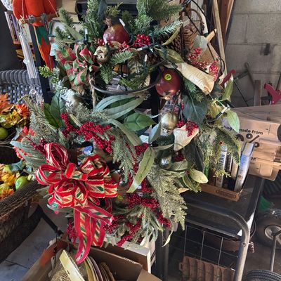 Sale Photo Thumbnail #40: Festive holiday wreath with faux greenery, pomegranates, red berries, light string, and a large red and gold plaid ribbon bow.
