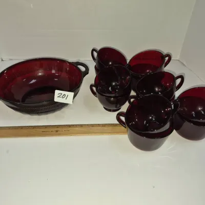 Sale Photo Thumbnail #342: Vintage ruby red glass punch set featuring a large ribbed oval bowl with handles and eight matching glass cups.