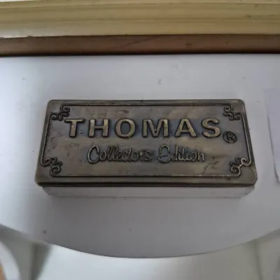 Sale Photo Thumbnail #677: Close-up of a metal "Thomas Collector's Edition" badge mounted on a vintage-style novelty radio or player cabinet.