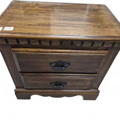 Sale Photo Thumbnail #170: Traditional dark oak nightstand with two drawers, dentil molding trim, and dark metal shell-style handles.