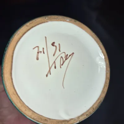 Sale Photo Thumbnail #42: Hand-painted pottery or ceramic piece showing an artist's signature and numbering on the underside base.