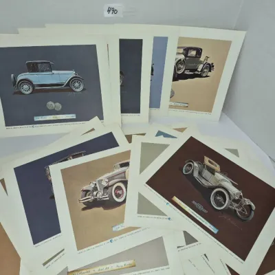 Sale Photo Thumbnail #838: Collection of vintage art prints depicting classic antique automobiles, including models from Pontiac, Chevrolet, and Packard.