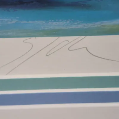 Sale Photo Thumbnail #505: Close-up detail of a pencil signature on an artist's print, featuring a matted border in blue and green tones.