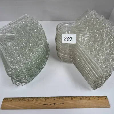 Sale Photo Thumbnail #358: Two stacks of vintage fan-shaped pressed glass salad or dessert plates featuring a daisy and button pattern.