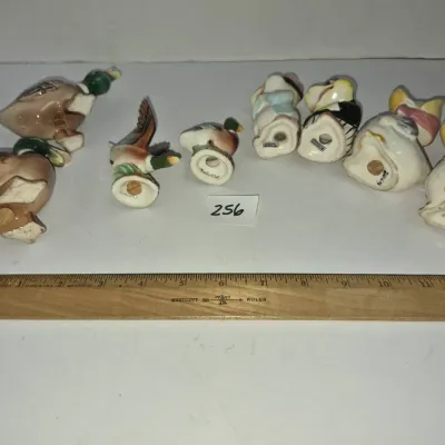 Sale Photo Thumbnail #438: Collection of eight vintage ceramic bird salt and pepper shakers featuring ducks and anthropomorphic characters, displayed alongside a 12-inch Westcott ruler for scale.