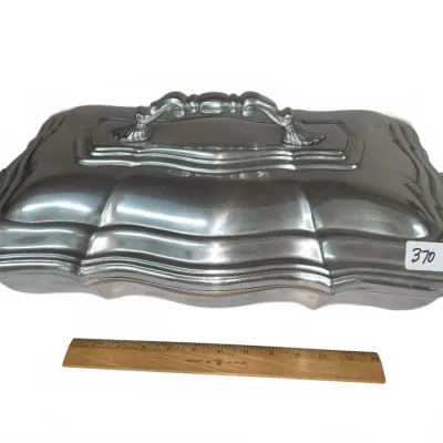 Sale Photo Thumbnail #641: Vintage pewter or silver-plated covered rectangular serving dish featuring a stepped, contoured lid with an ornate handle.