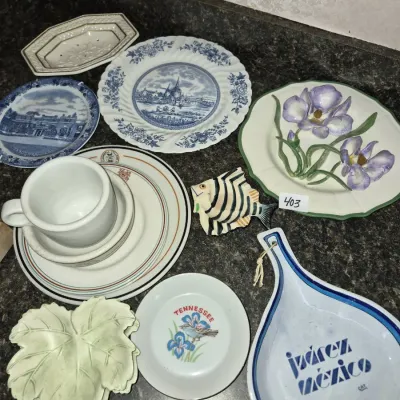 Sale Photo Thumbnail #711: Collection of decorative vintage ceramics, including souvenir plates, a leaf-shaped dish, a ceramic fish figurine, and a Juárez, México teardrop dish.