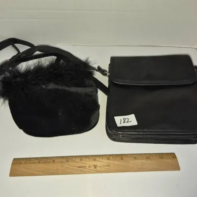 Sale Photo Thumbnail #313: Pair of black handbags, including a velvet purse with feather trim and a structured flap-closure leather crossbody bag.