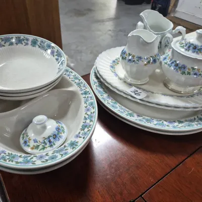 Sale Photo Thumbnail #56: Vintage fine china tableware set featuring a blue and teal floral motif, including creamer, sugar bowl, serving platters, and shallow bowls.