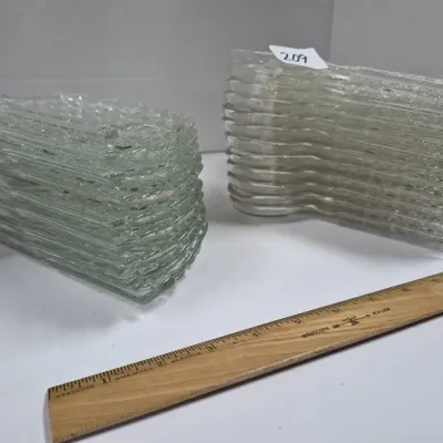 Sale Photo Thumbnail #359: Two stacks of vintage clear textured glass snack or crescent plates, featured alongside a wooden ruler for scale.