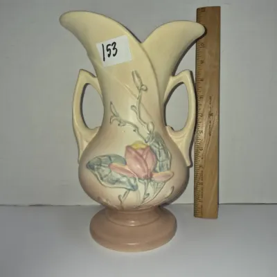 Sale Photo Thumbnail #262: Vintage Roseville Pottery Magnolia double-handled vase in matte tan and pink, standing approximately 12 inches tall.