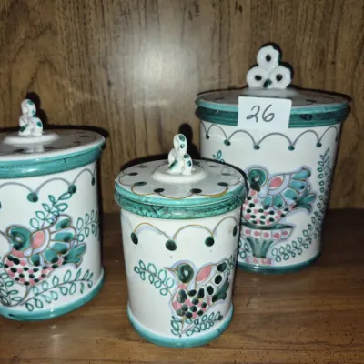 Sale Photo Thumbnail #40: Set of three vintage hand-painted ceramic canisters featuring colorful bird motifs and green trim.