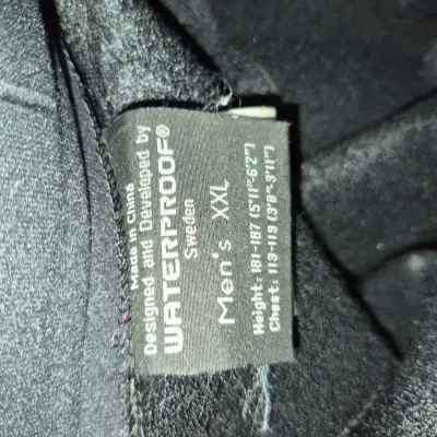 Sale Photo Thumbnail #321: Clothing tag for a Waterproof Sweden men's size XXL garment.