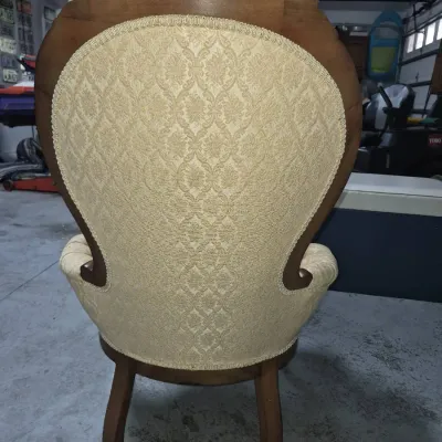 Sale Photo Thumbnail #15: Rear view of a Victorian-style armchair featuring carved wooden trim and light gold damask fabric upholstery.