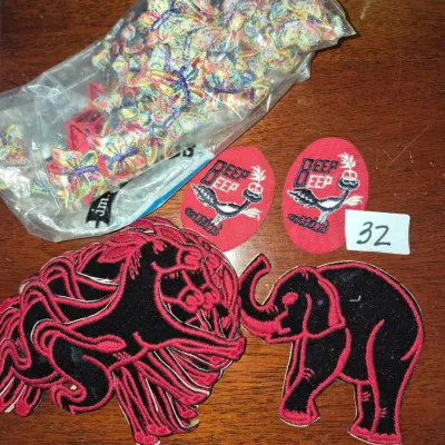 Sale Photo Thumbnail #49: Collection of vintage embroidered iron-on patches featuring a bag of colorful butterflies, black and red animals, and Road Runner 'Beep Beep' designs.