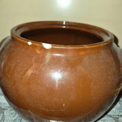 Sale Photo Thumbnail #635: Vintage brown glazed ceramic bean pot showing minor rim chips and surface wear.
