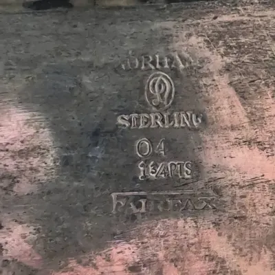 Sale Photo Thumbnail #927: Close-up of maker's marks on a piece of Gorham sterling silver in the Fairfax pattern, indicating a 1 3/4 pint capacity.