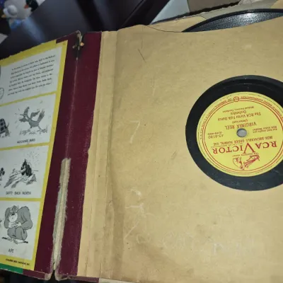 Sale Photo Thumbnail #753: Vintage Bugs Bunny record album book with an RCA Victor folk dance 78 RPM vinyl record, showing age-related wear to the spine and sleeves.