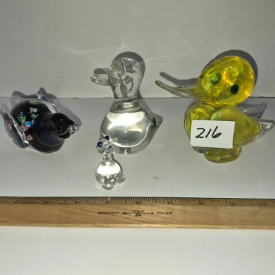Sale Photo Thumbnail #369: Collection of four vintage art glass duck figurines in various colors and sizes, including millefiori and clear glass designs.