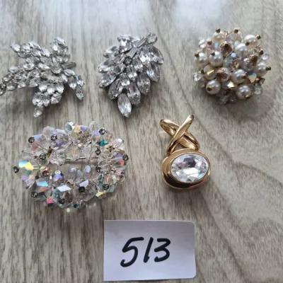 Sale Photo Thumbnail #885: Collection of five vintage costume brooches and pendants, including rhinestone cluster, faux pearl, and aurora borealis crystal designs.