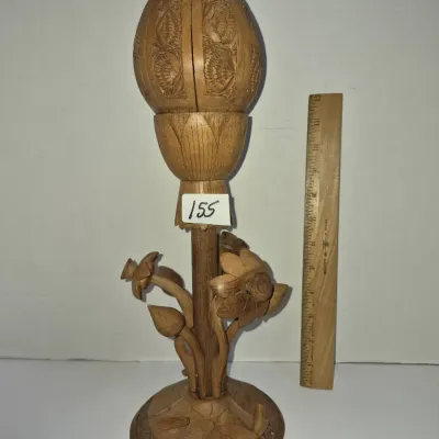 Sale Photo Thumbnail #270: Hand-carved wooden lotus sculpture featuring a detailed bud atop floral stems and a round carved base, measuring approximately 12 inches tall.