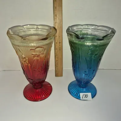 Sale Photo Thumbnail #293: Pair of vintage ombré pressed glass footed vases featuring embossed floral details, including one red-to-yellow and one blue-to-green gradient.