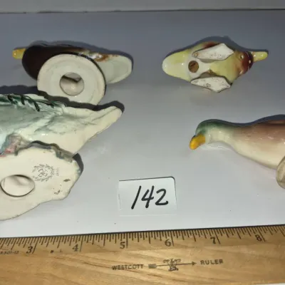 Sale Photo Thumbnail #241: Set of four vintage ceramic duck figurines shown from the underside, including a larger mallard with a maker's mark and three smaller duck salt and pepper shakers.